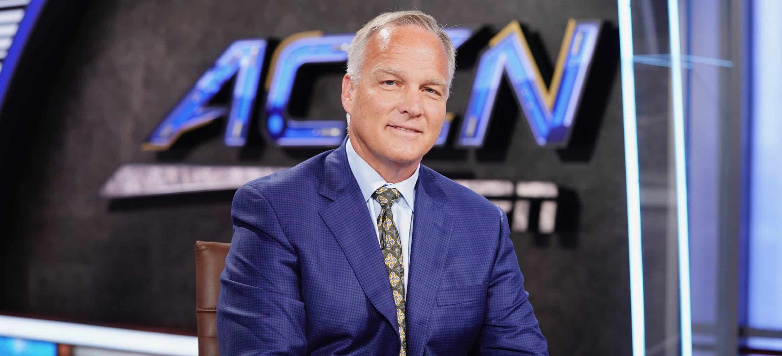 Mark Richt in a blue suit and patterned tie sits in a studio with an ACCN and ESPN logo displayed behind him.