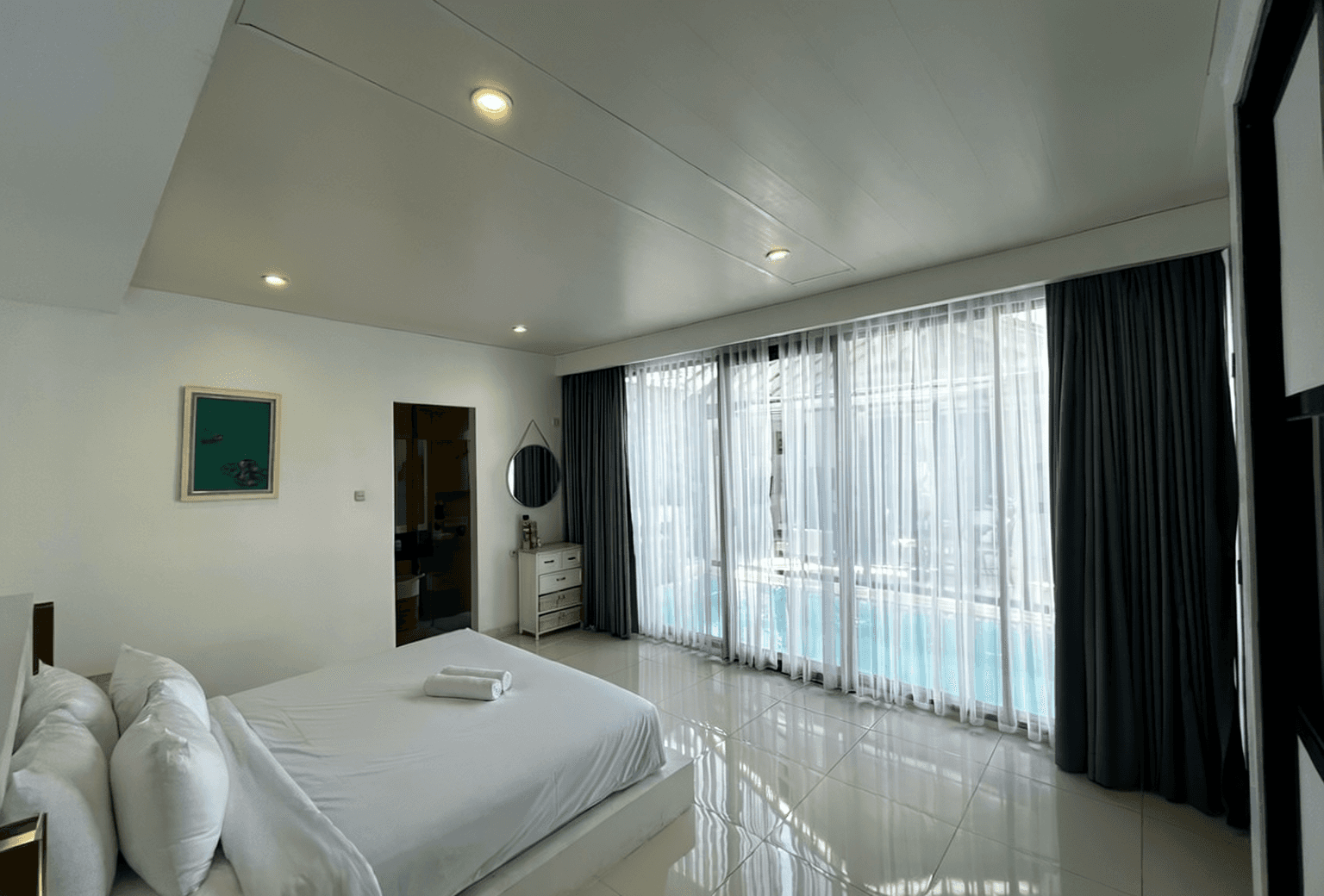 Minimalist luxury bedroom with pool access. Find your dream Nyanyi Beach home with our expert real estate team.