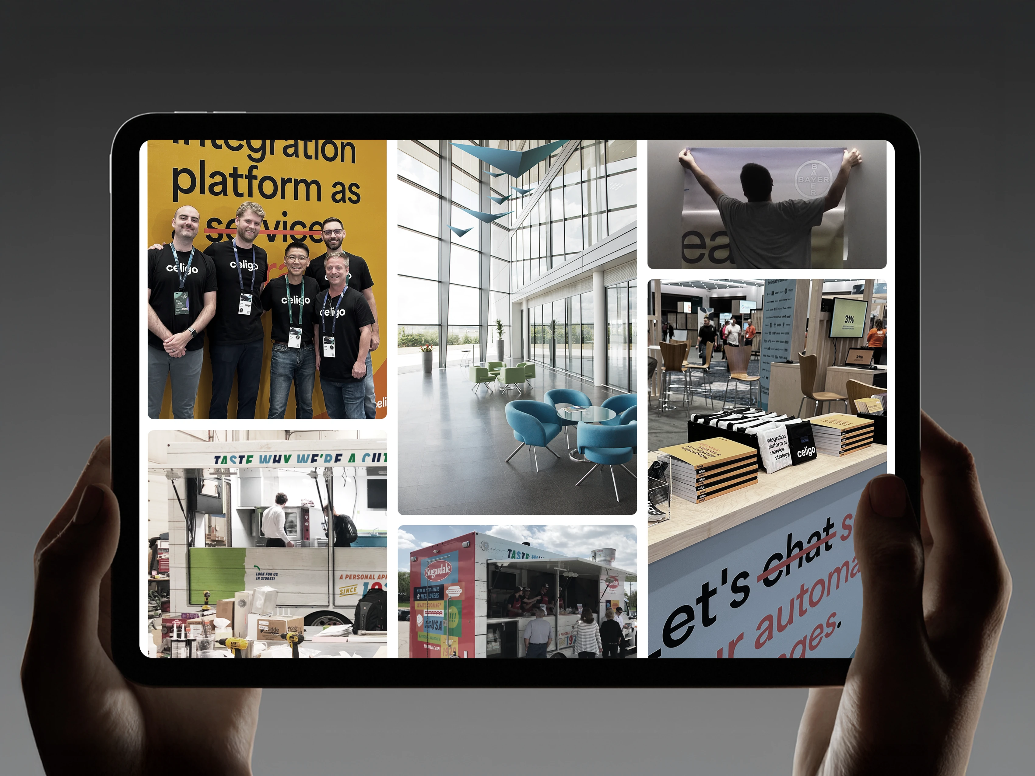 Hands holding a tablet with photos from marketing events on the screen