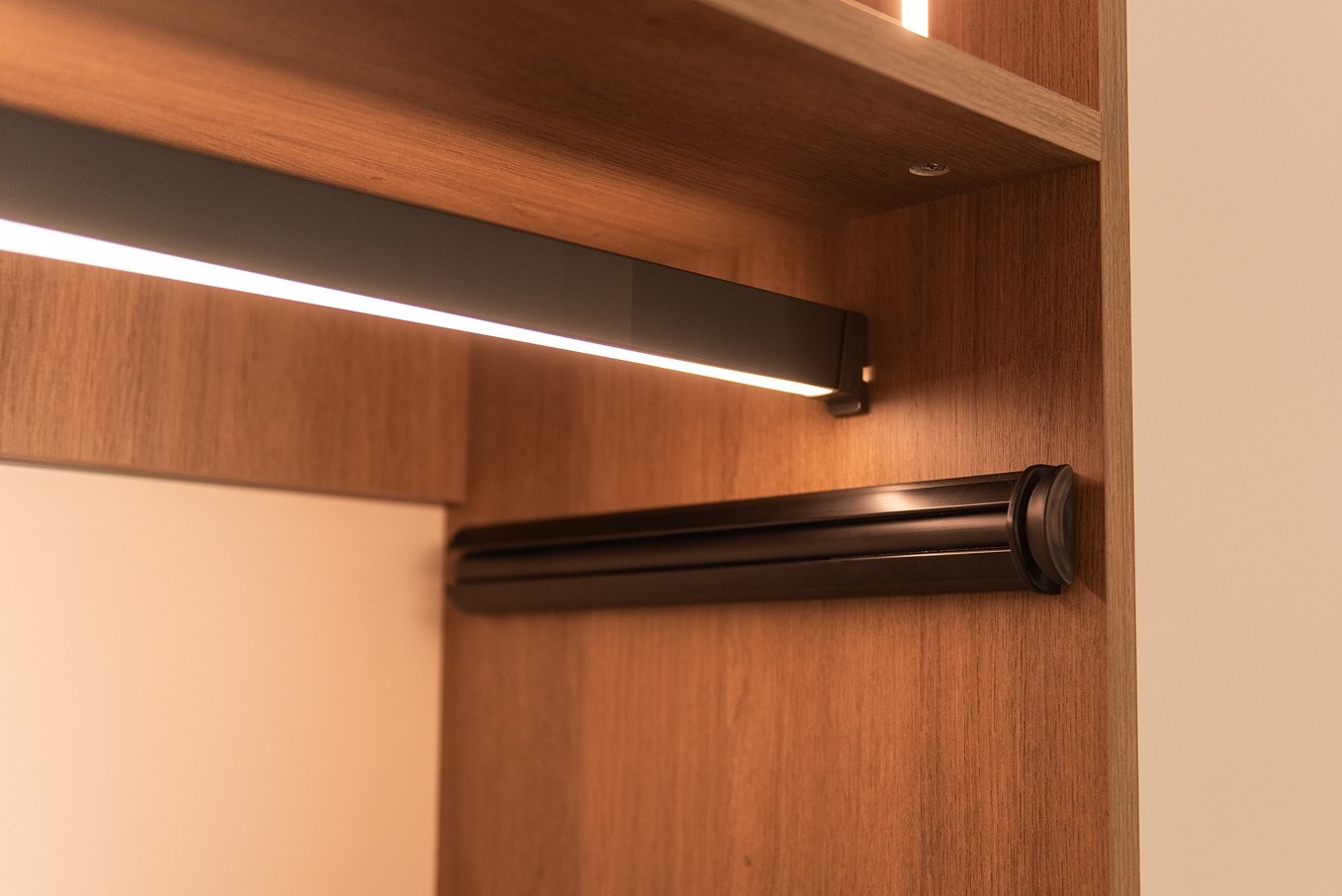 LED-lit hanging rod in custom closet