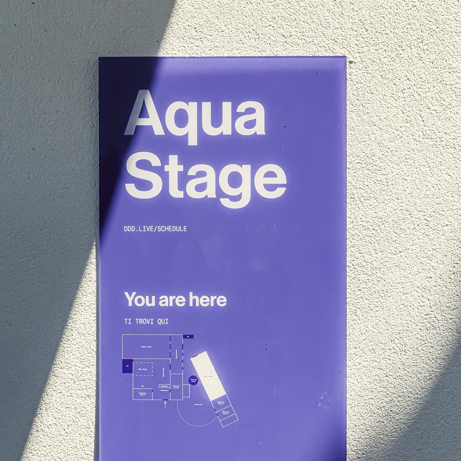 Plexiglass wayfinding board featuring the Aqua Stage and a map indicating where the visitor currently is located.