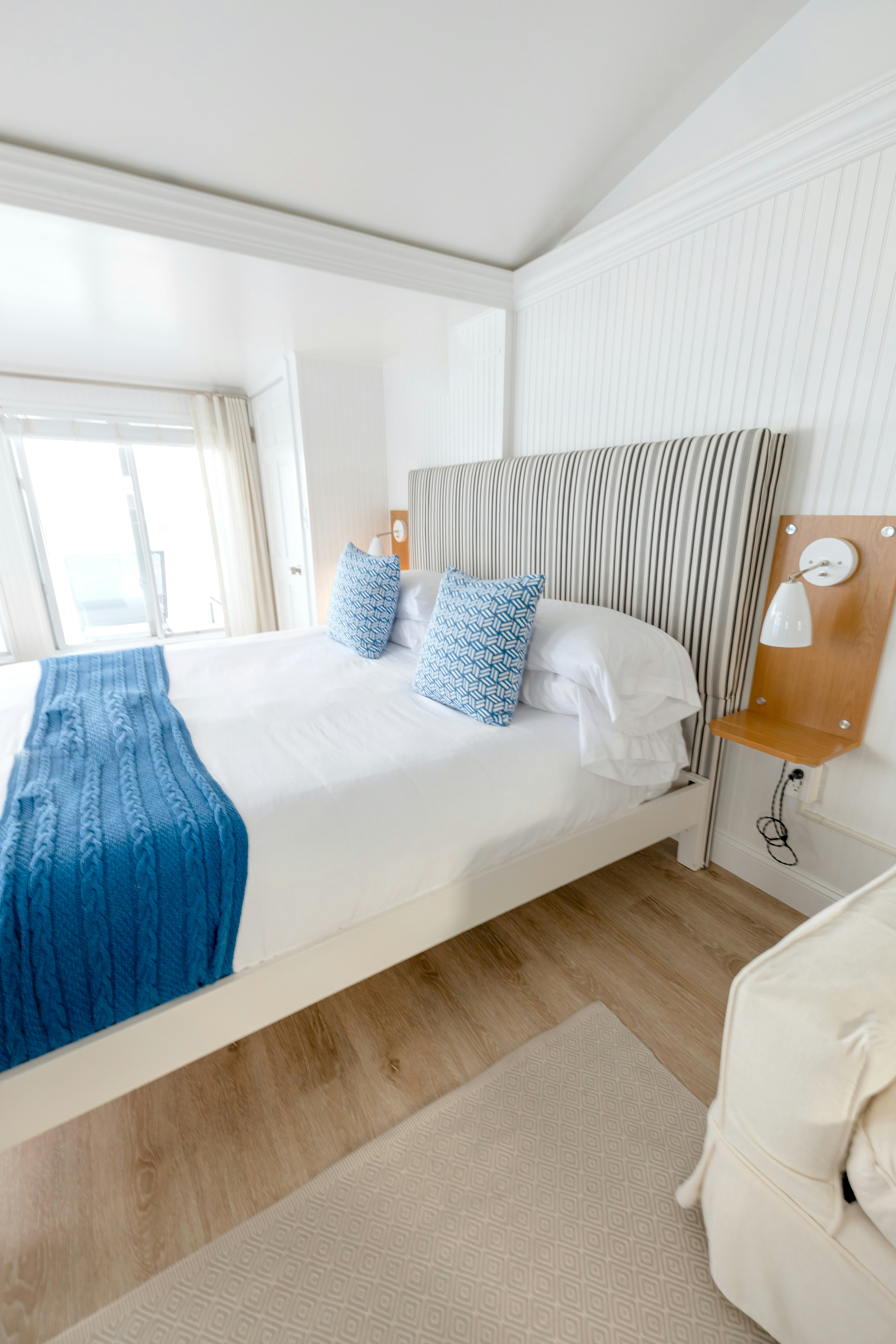 A cozy bedroom with a king-size bed and blue accents