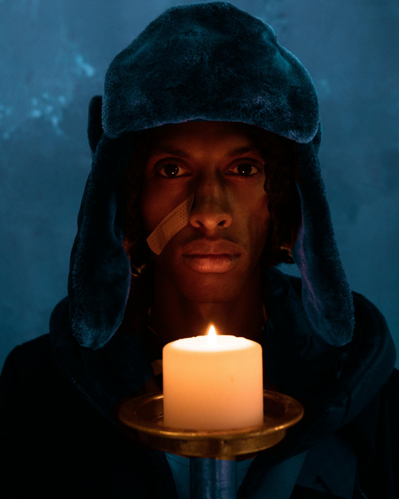 Moody fashion portrai of a man with fur hat