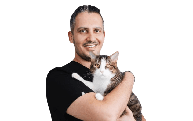 An image of Dr. J holding a cat in his arms.