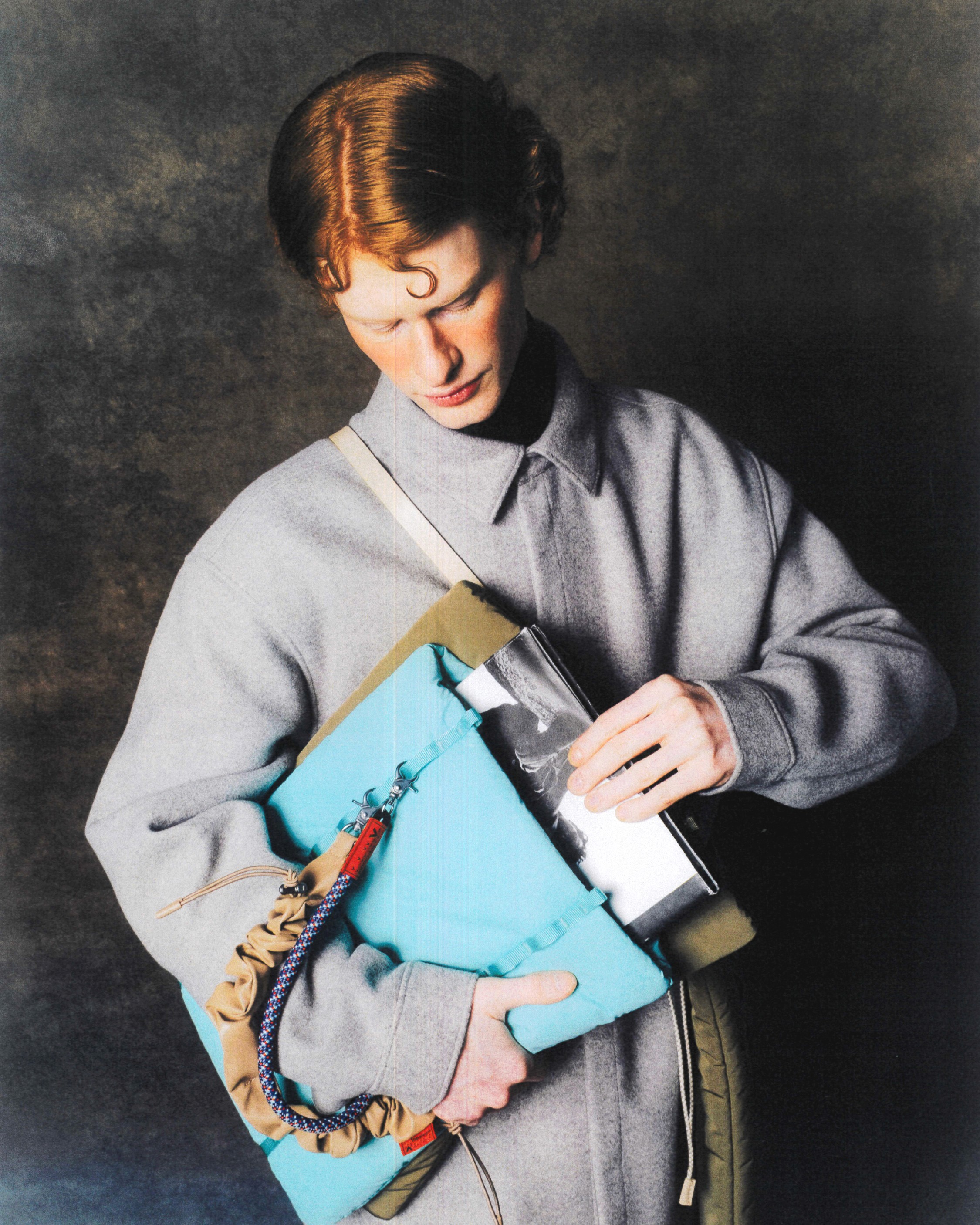 Un mannequin cherche dans un sac bleu ciel son ordianteur