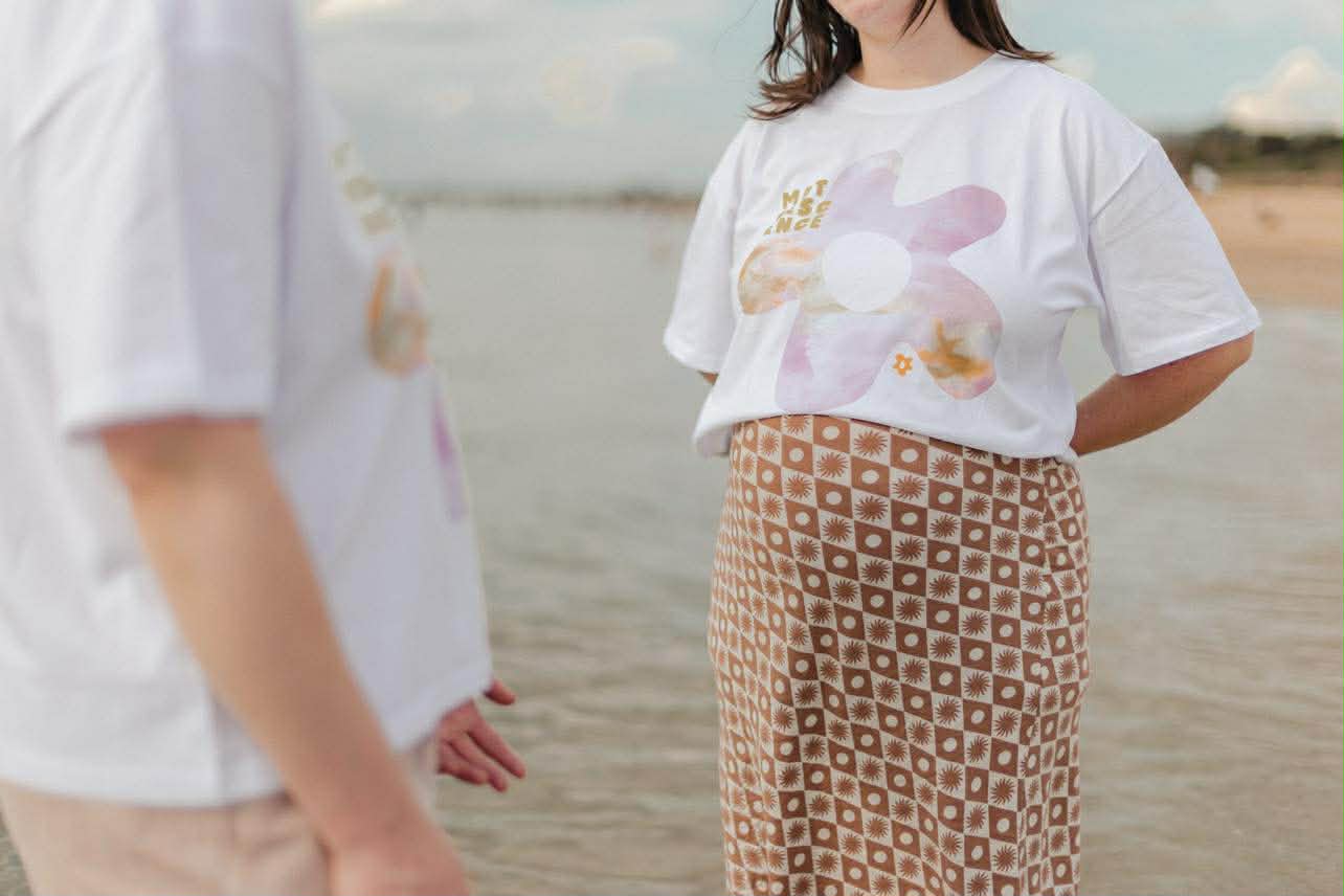 Pregnant woman's belly illuminated by sunlight.