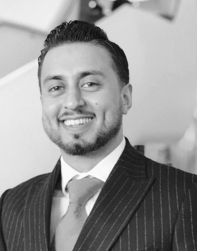 Portrait of a person in dark clothing speaking on a phone