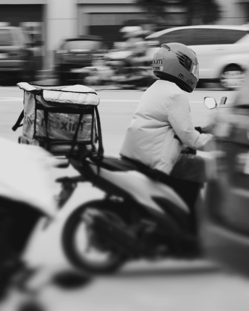 A person on a motor scooter on a city street