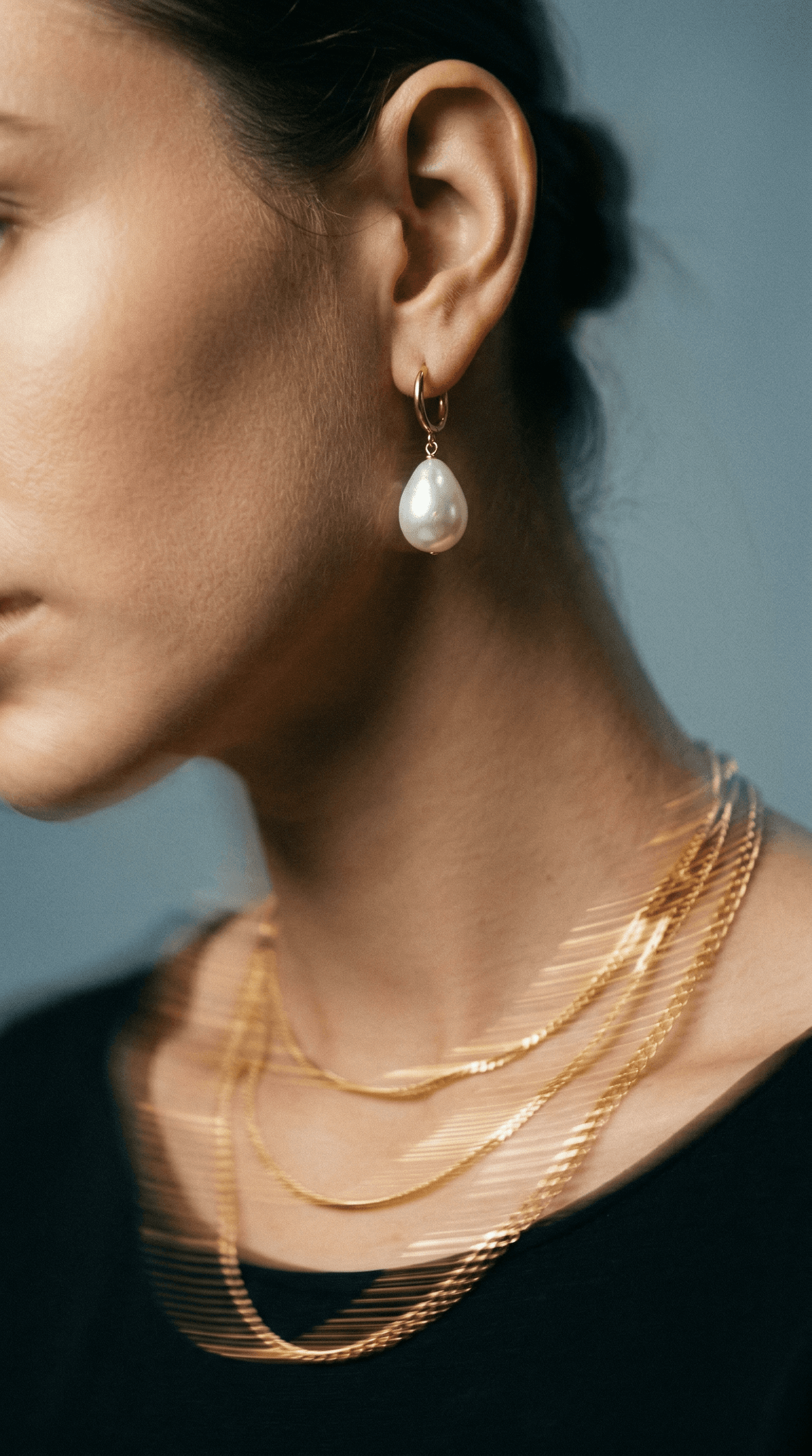 Moody portrait with hand covering eyes wearing statement diamond rings