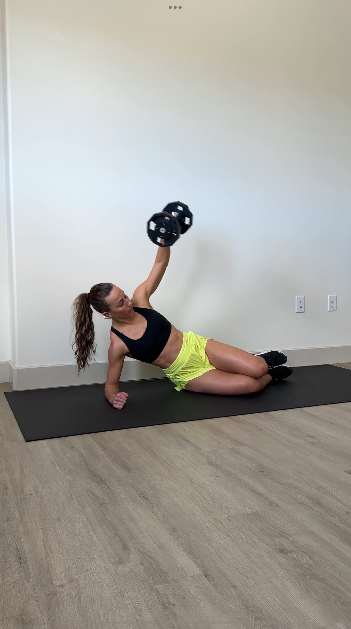 A person checking real-time fitness activity insights on a mobile device in a calm natural environment.