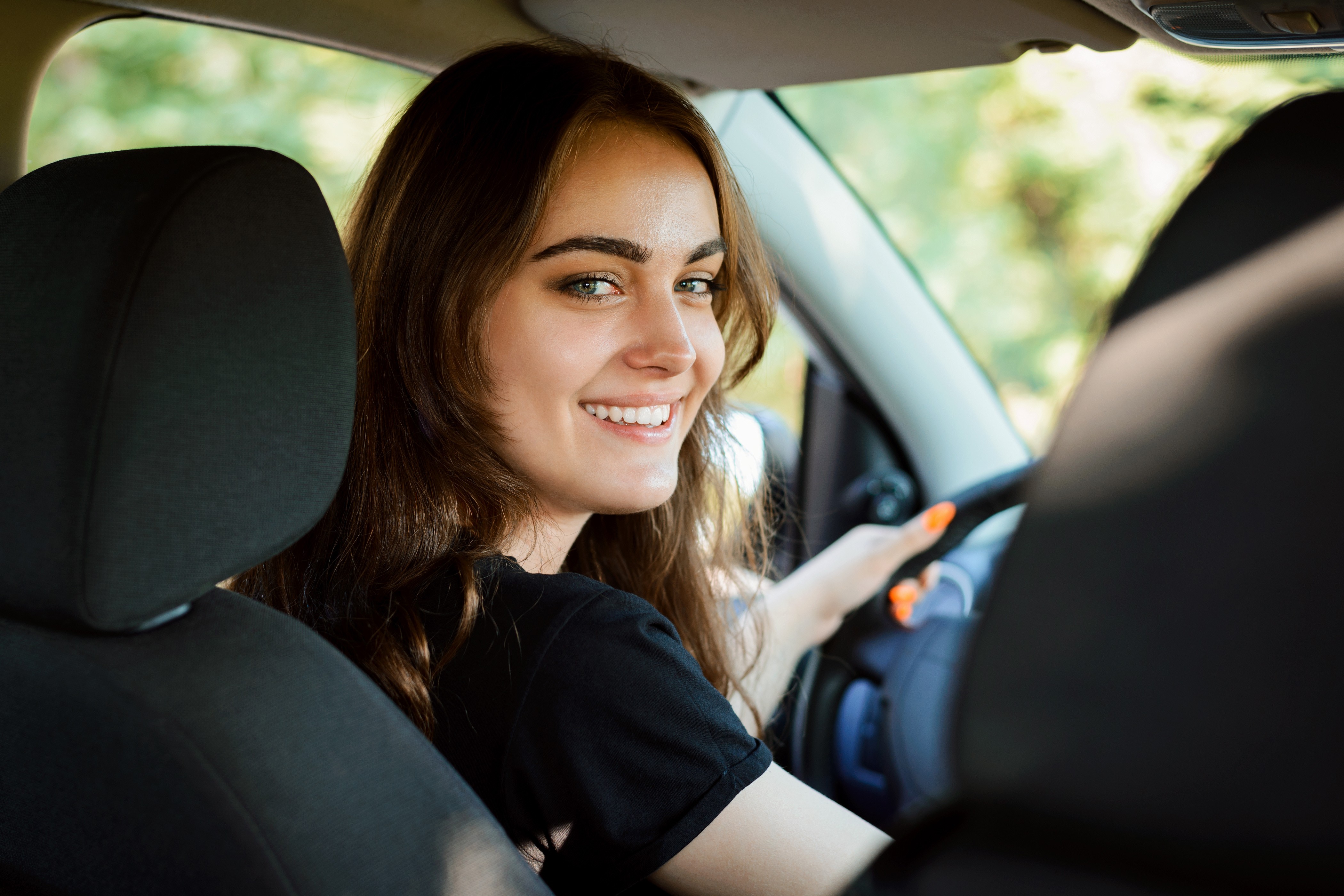 Happy woman in Wichita, KS with reliable auto insurance coverage