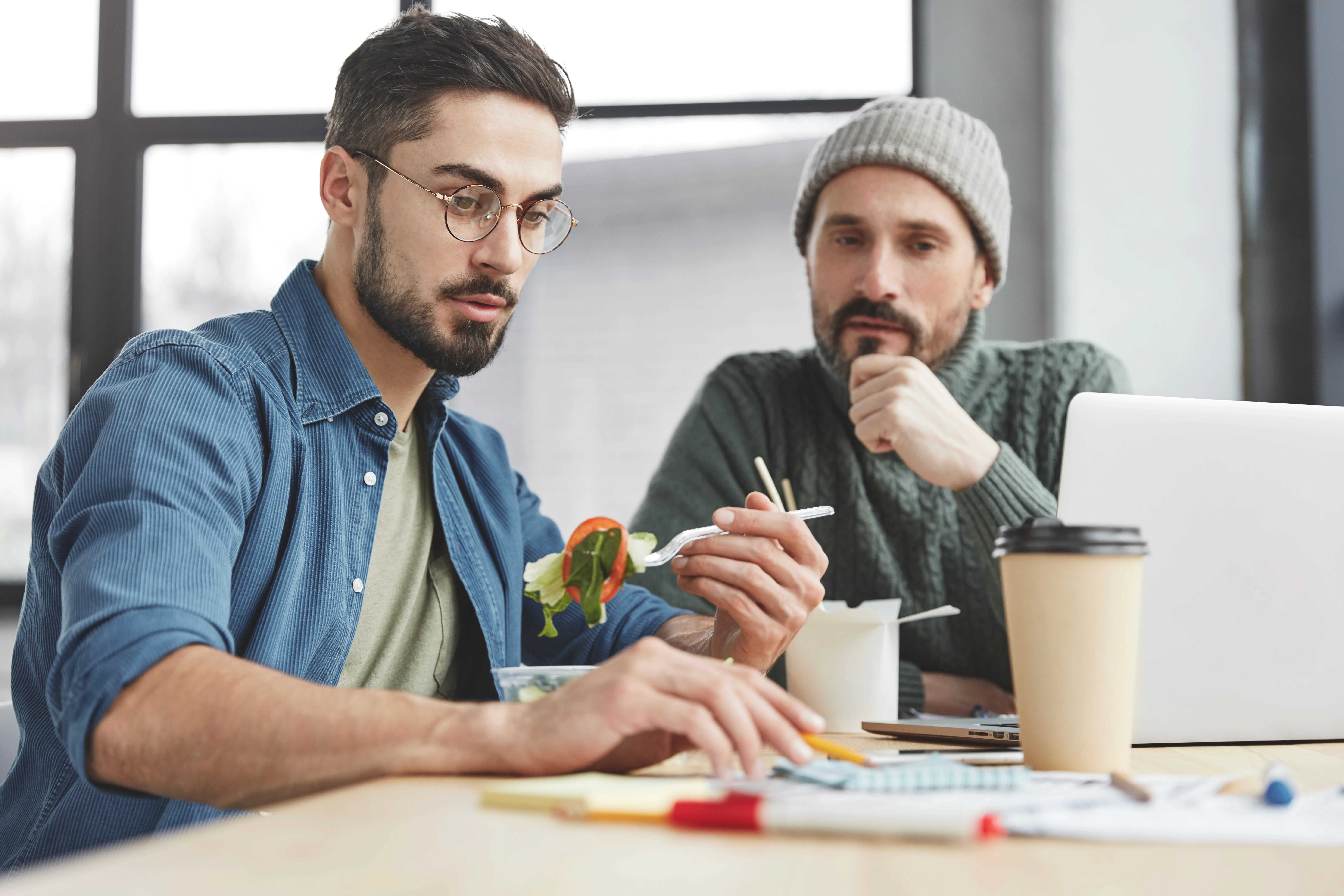 male-coworkers-office-with-lunch