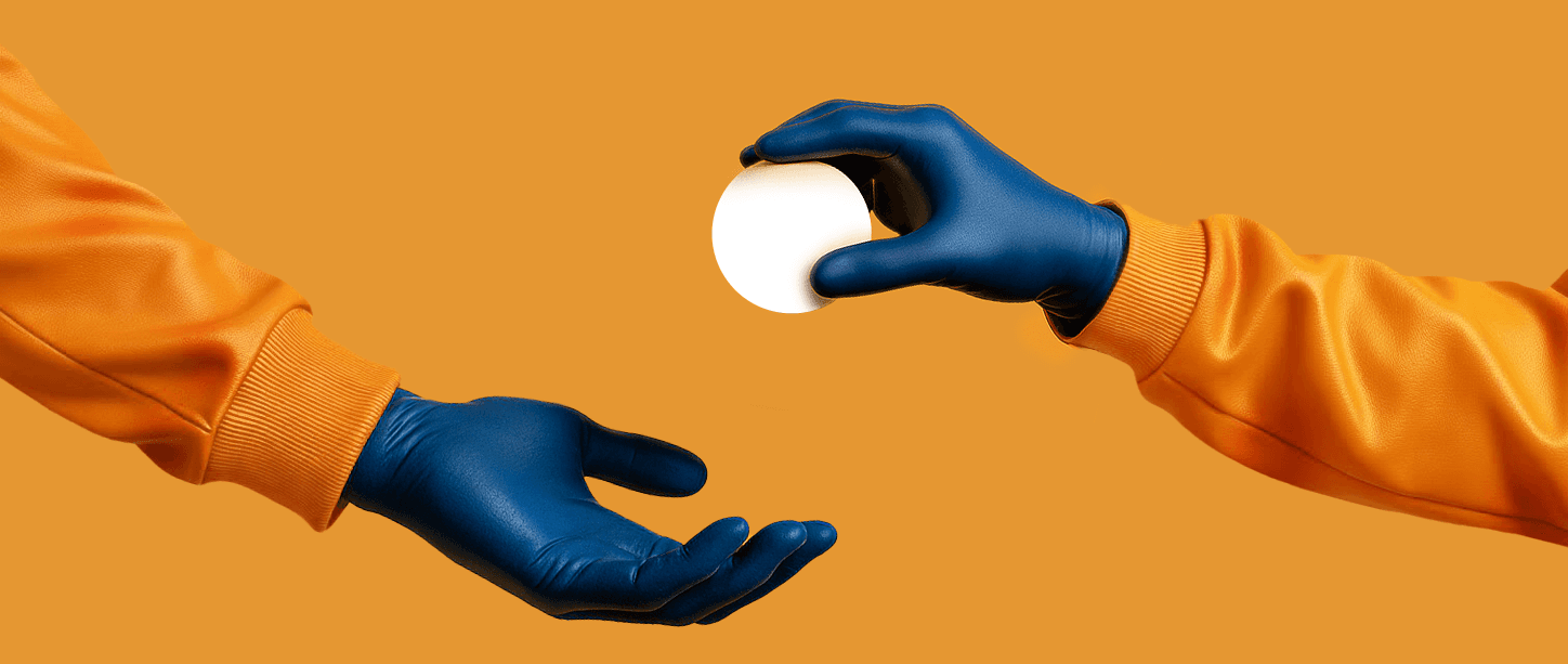 Two gloved hands wearing orange sleeves reaching toward each other against an orange background, one holding a glowing white sphere, symbolizing connectivity and exchange.