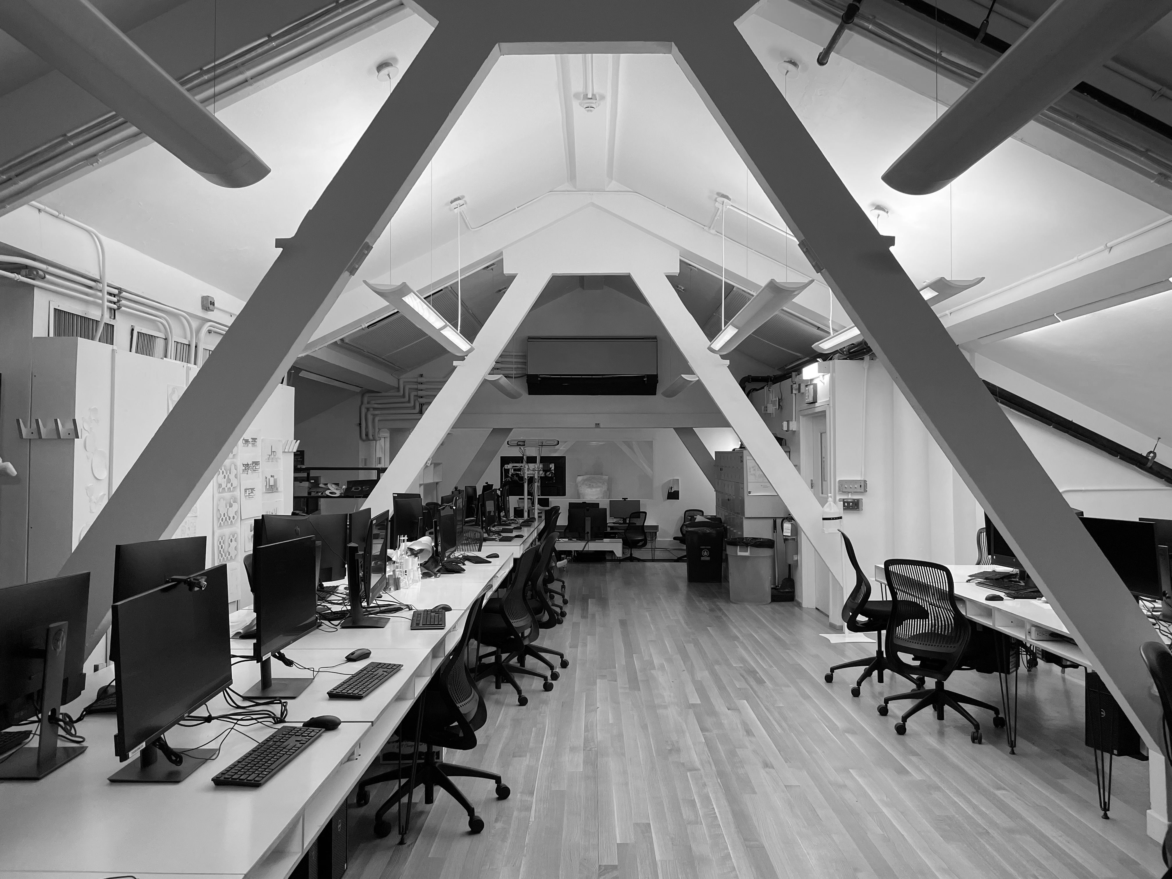 monochrome-view-of-a-modern-computer-lab-featuring-sleek-monitors-and-ergonomic- - k-s (pexels)