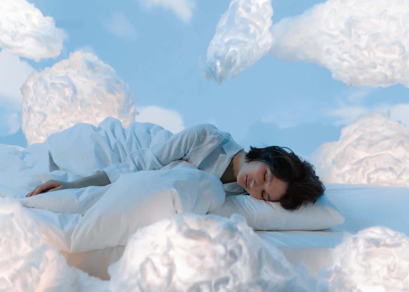 Yoga Nidra for deep sleep - Woman sleeping and surrounded by clouds