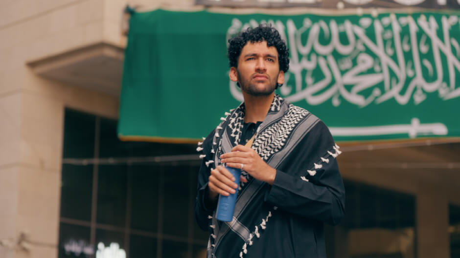 HAMZA ANWAR from the UK looking out wearing a Keffiyeh
