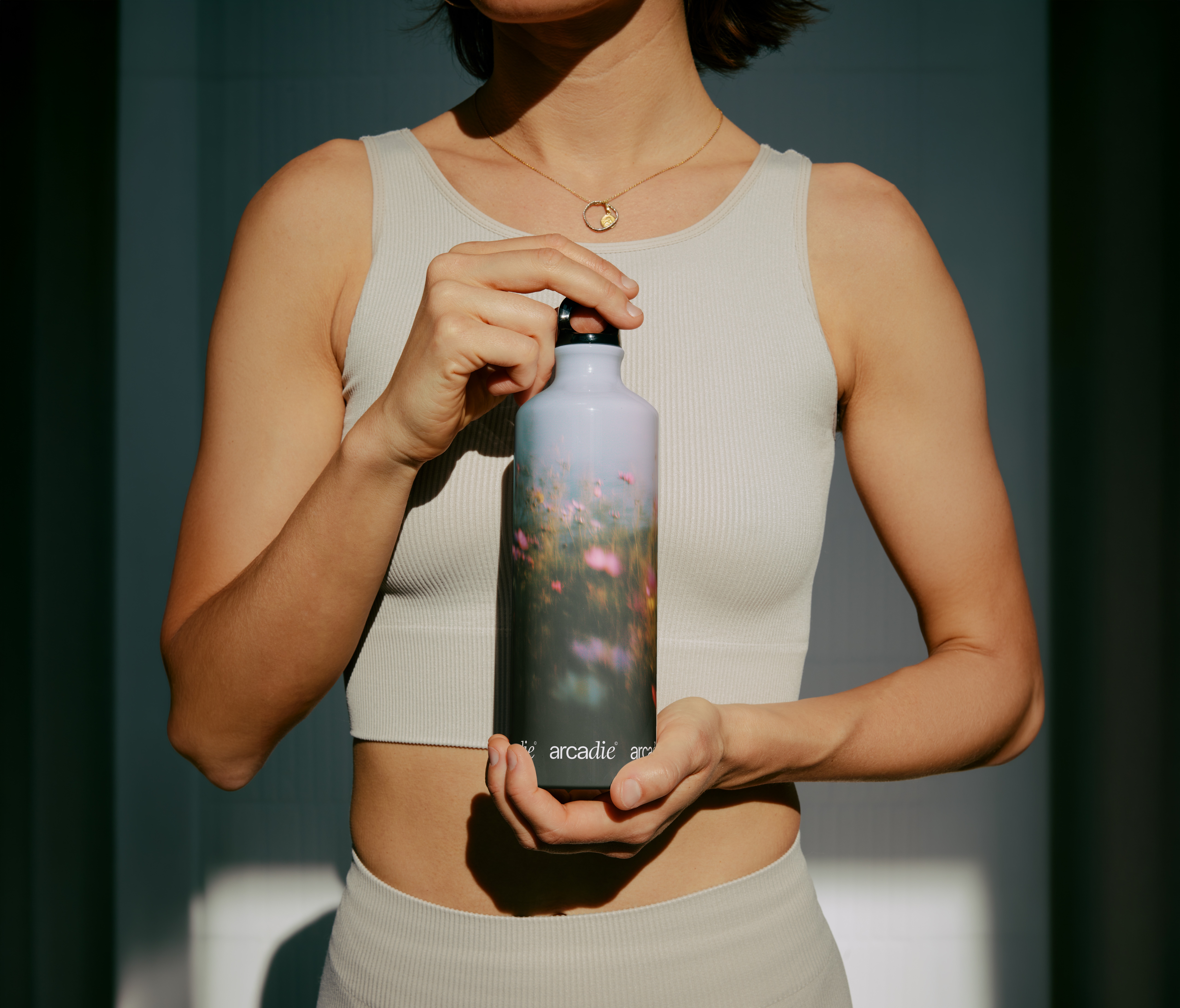 A close-up of a person wearing green-tinted glasses, with a serious expression and smooth skin.