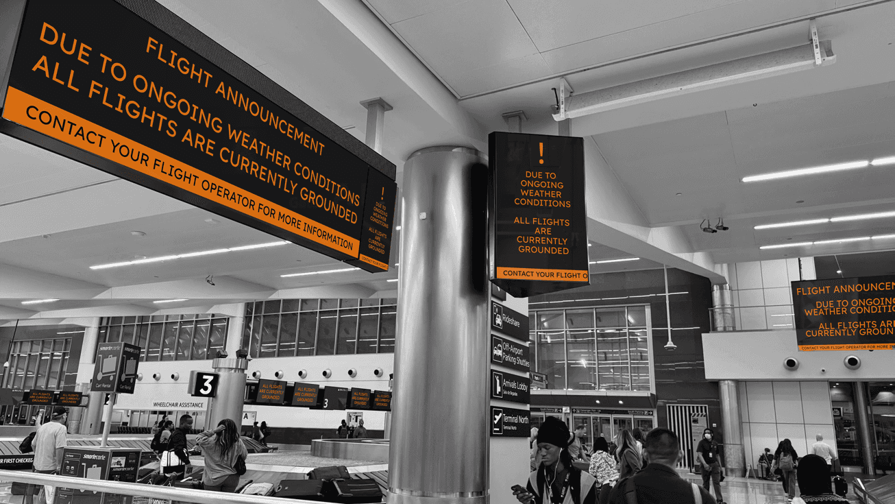 A photo of multiple screens in an airport showing the same flight announcement message