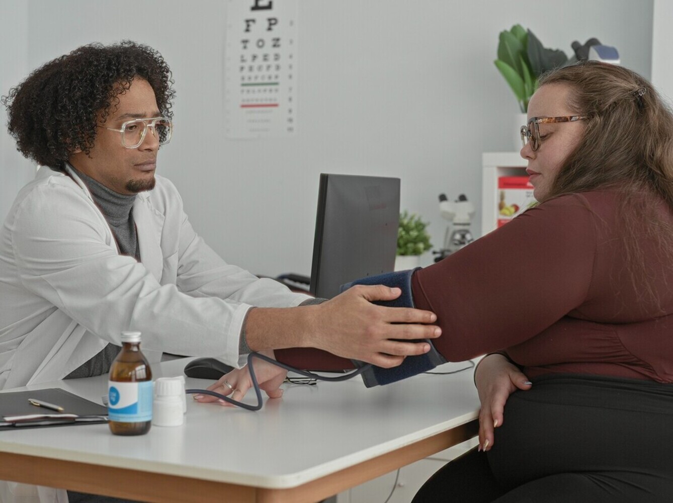 overweight woman meeting her doctor for a follow-up for her weight loss injection meds treatment plan