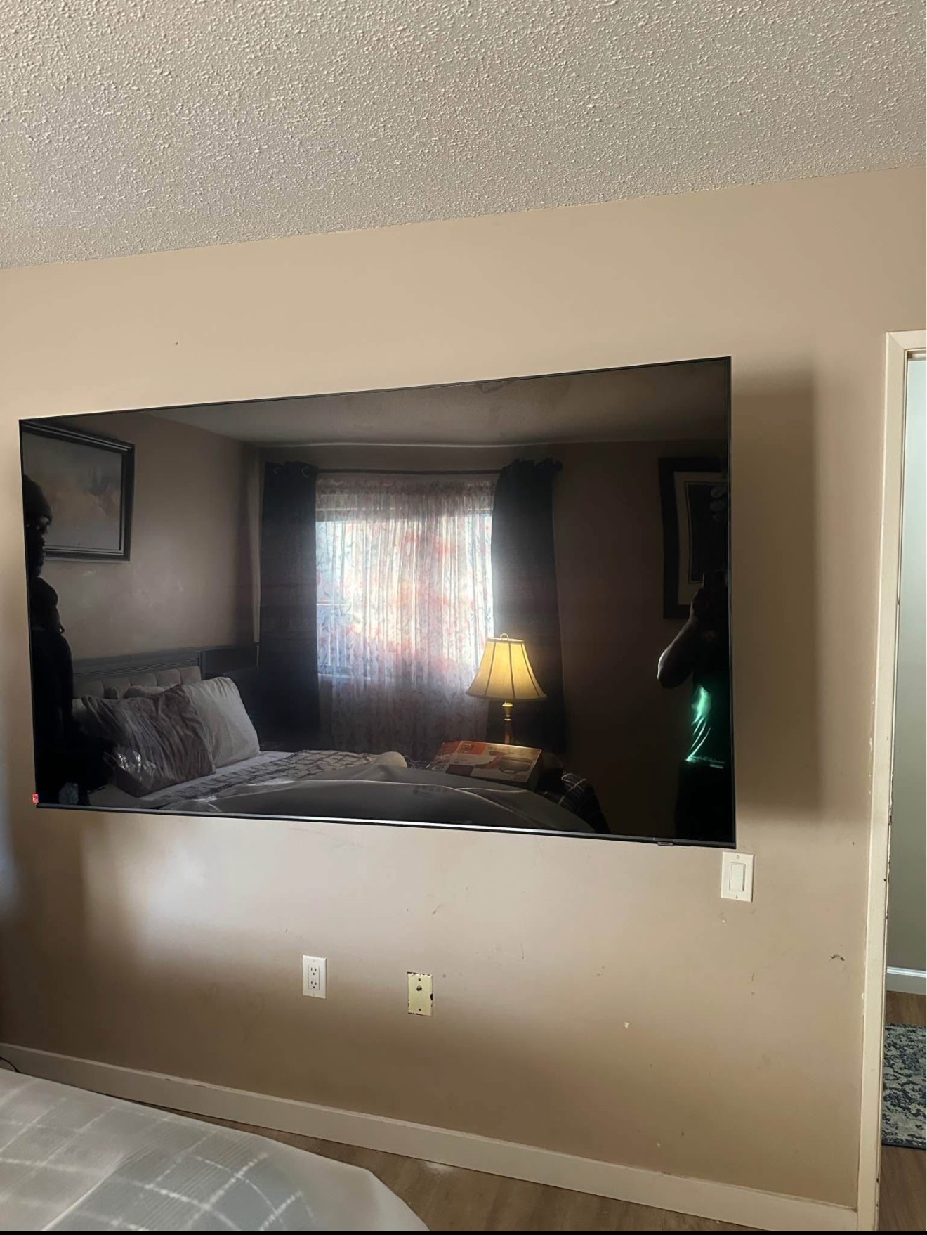 65-inch TV mounted using a swivel arm setup in a residential home in Tampa, with clean wiring and a modern look.
