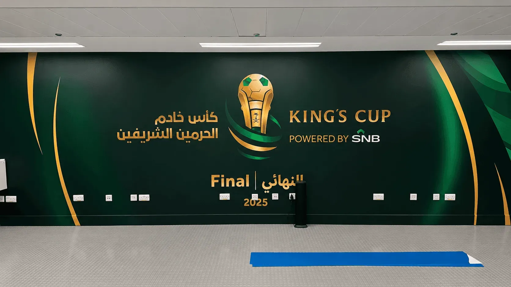 King's Cup Final 2025 wall branding installed in the stadium player room