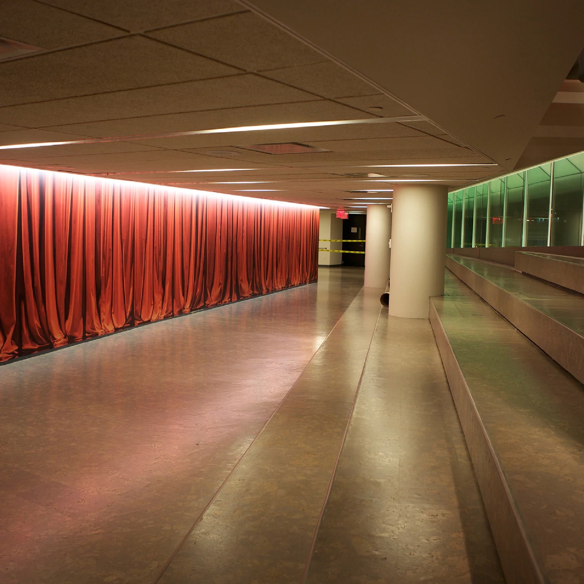 Mural installation that looks like luxurious red theater curtains.