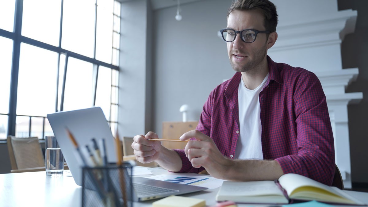 Business coach sitting at this desk during an online call