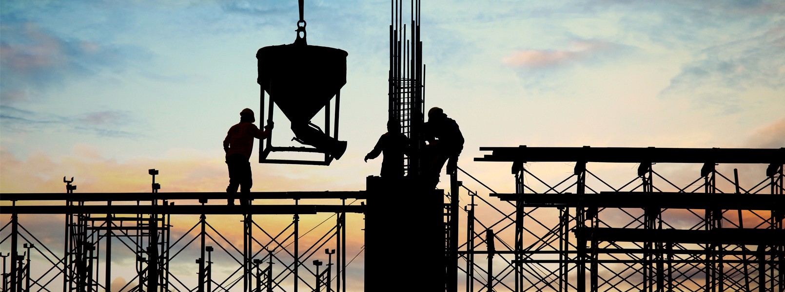 Construction workes during sunset 