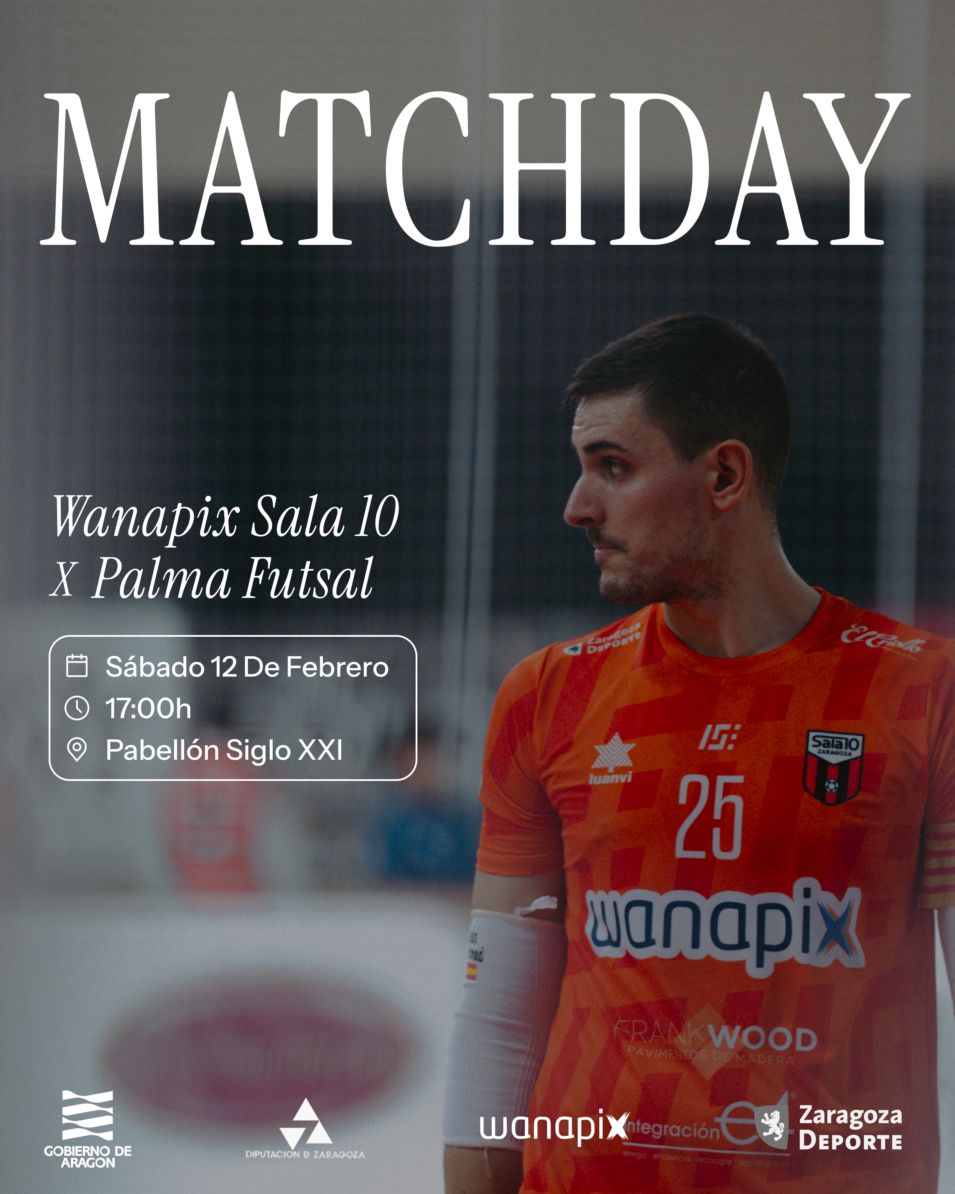 A view of a studio interior with modern decor, featuring large windows that offer a glimpse of lush greenery outside