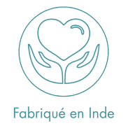 A woman lying down with a towel wrapped around her head, her face glistening with facial oil. Her eyes are closed, and she appears to be enjoying a spa treatment in a peaceful setting.