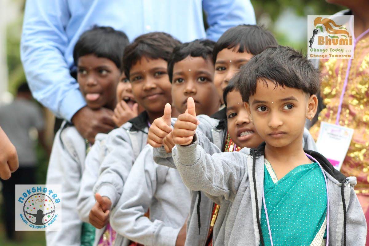 Children engage in an outdoor activity, with adults in the background participating. A sense of community is present.