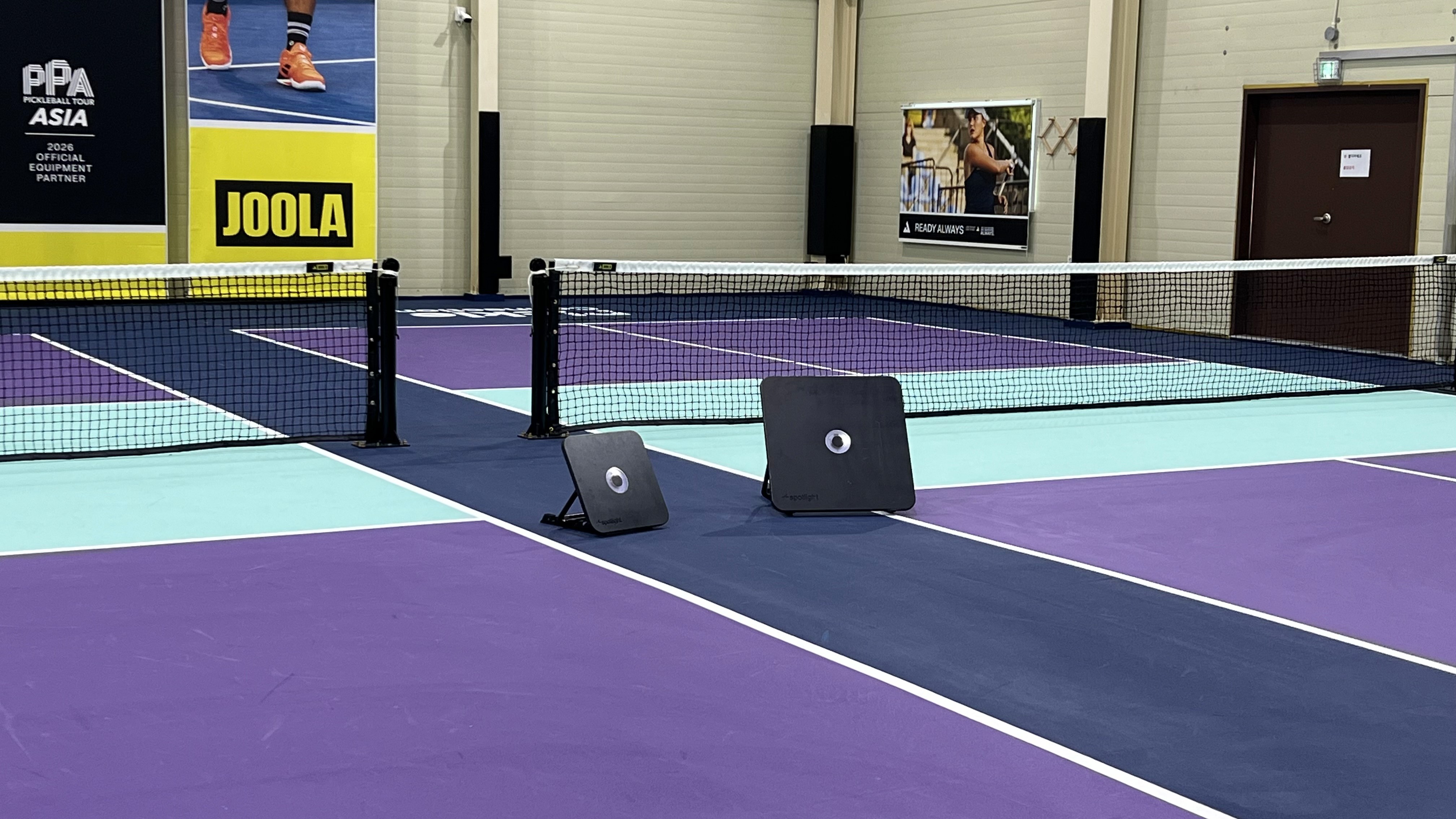 a person's feet with a ball on a purple carpet