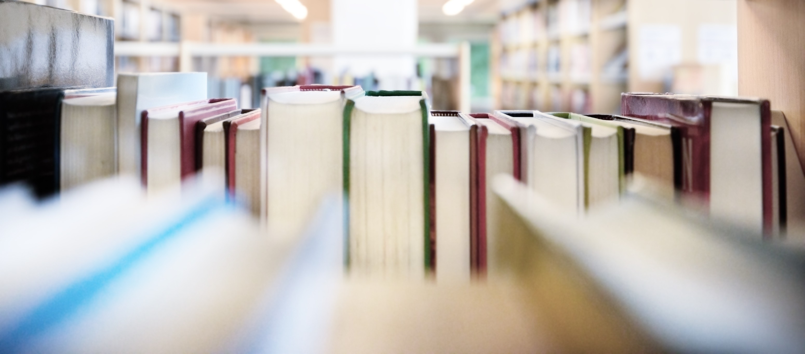 Close-up view of books lined up on library shelves