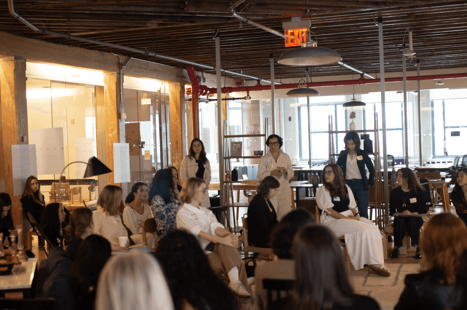 Group of women on chairs in a industrial space