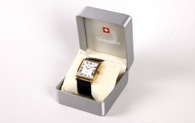 Adriatica watch presented in branded silver box – foil-stamped logo and Swiss cross on lid interior. Product packaging design by Abarel.