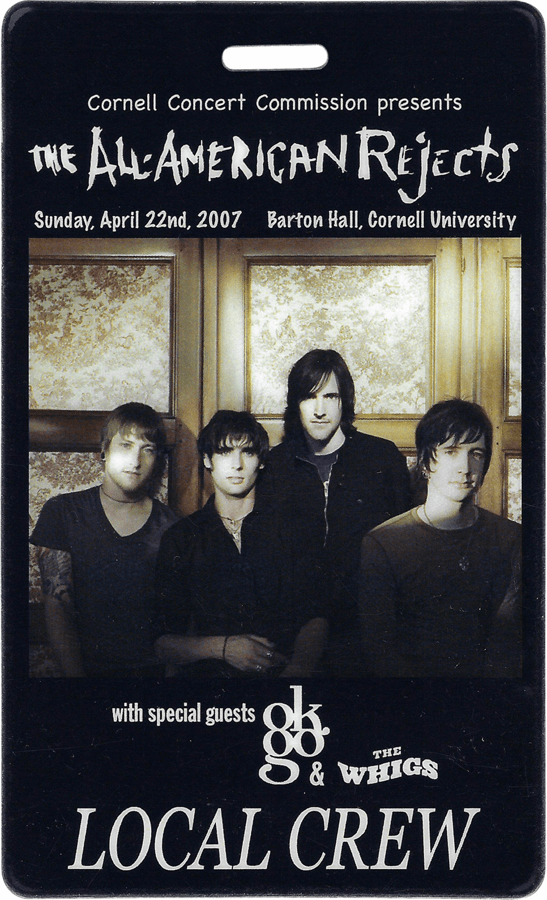 A backstage pass for a performance featuring a local crew, dated 1987, with a black and white group photo.