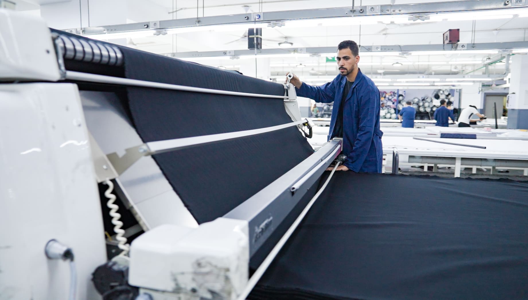 Worker uses spreading machine.