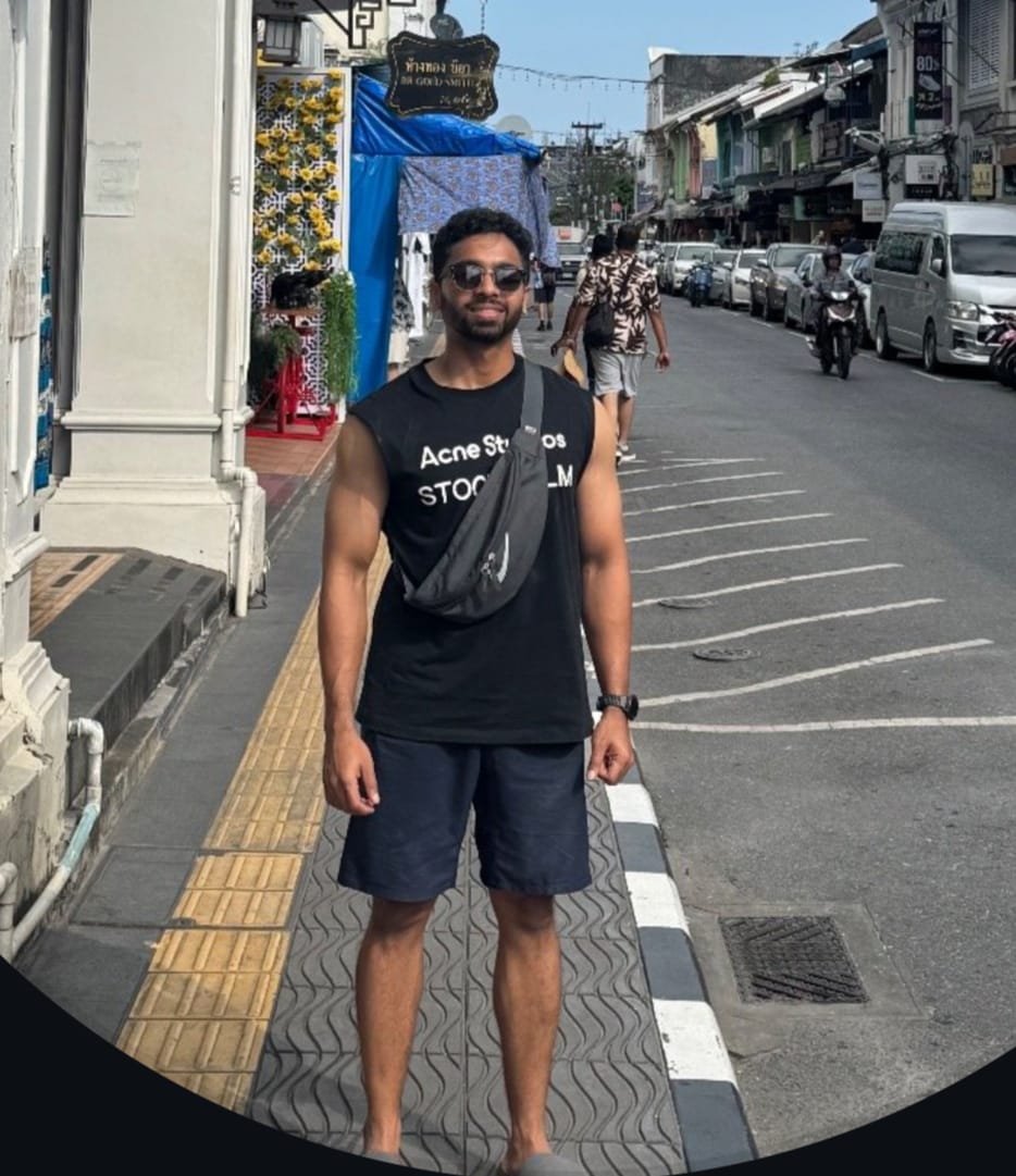 woman standing by wall holding mug