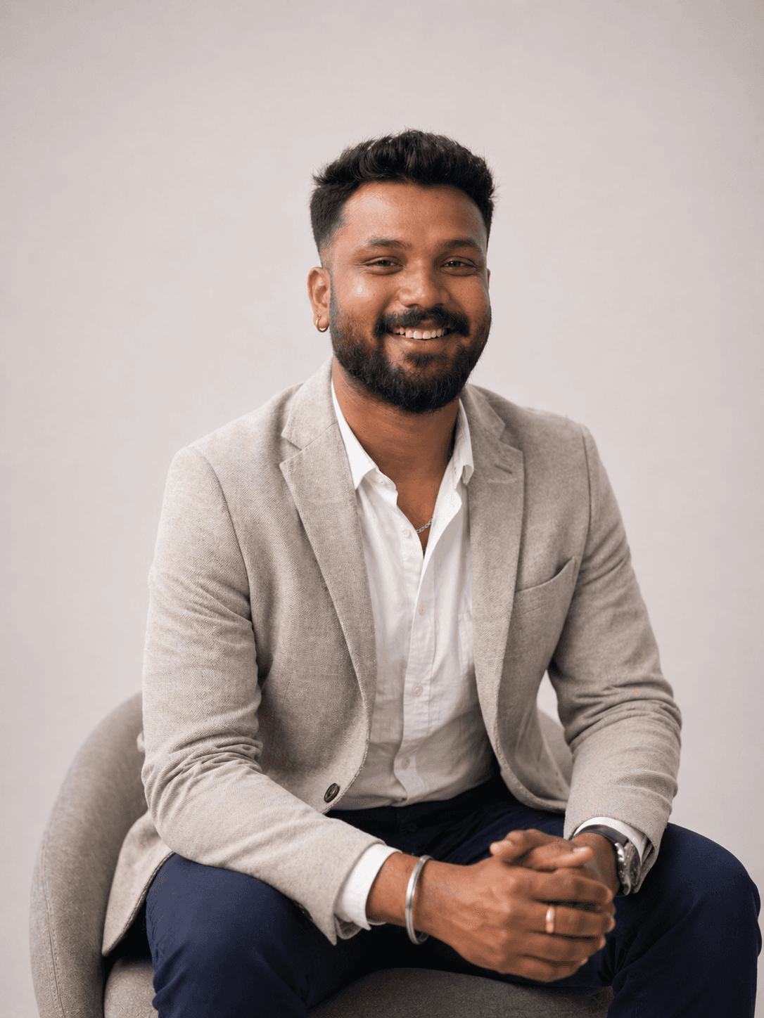 Dipesh Dhruv, Visual Editor, smiling in an outdoor workspace environment