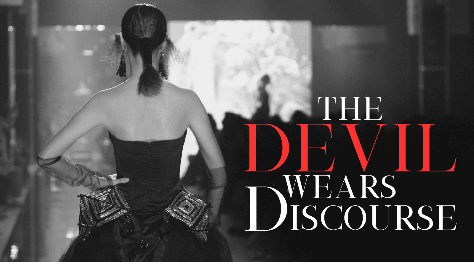 A model walks a runway in an avante garde dress, next to the blog title, "The Devil Wears Discourse"