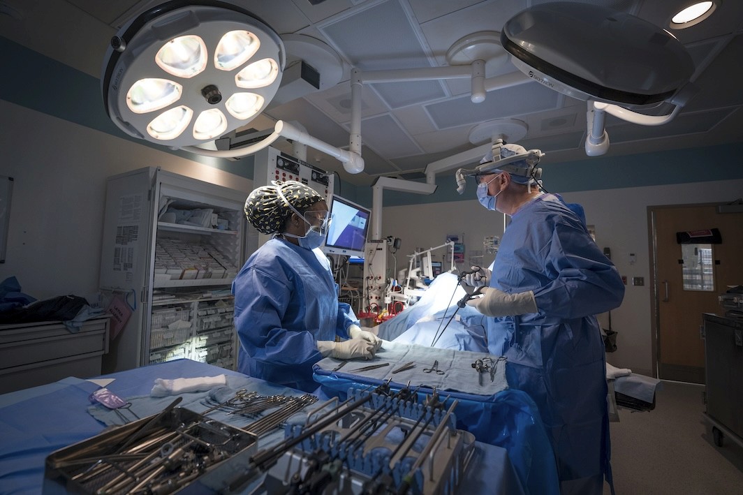 A surgeon and assistant in an operating room