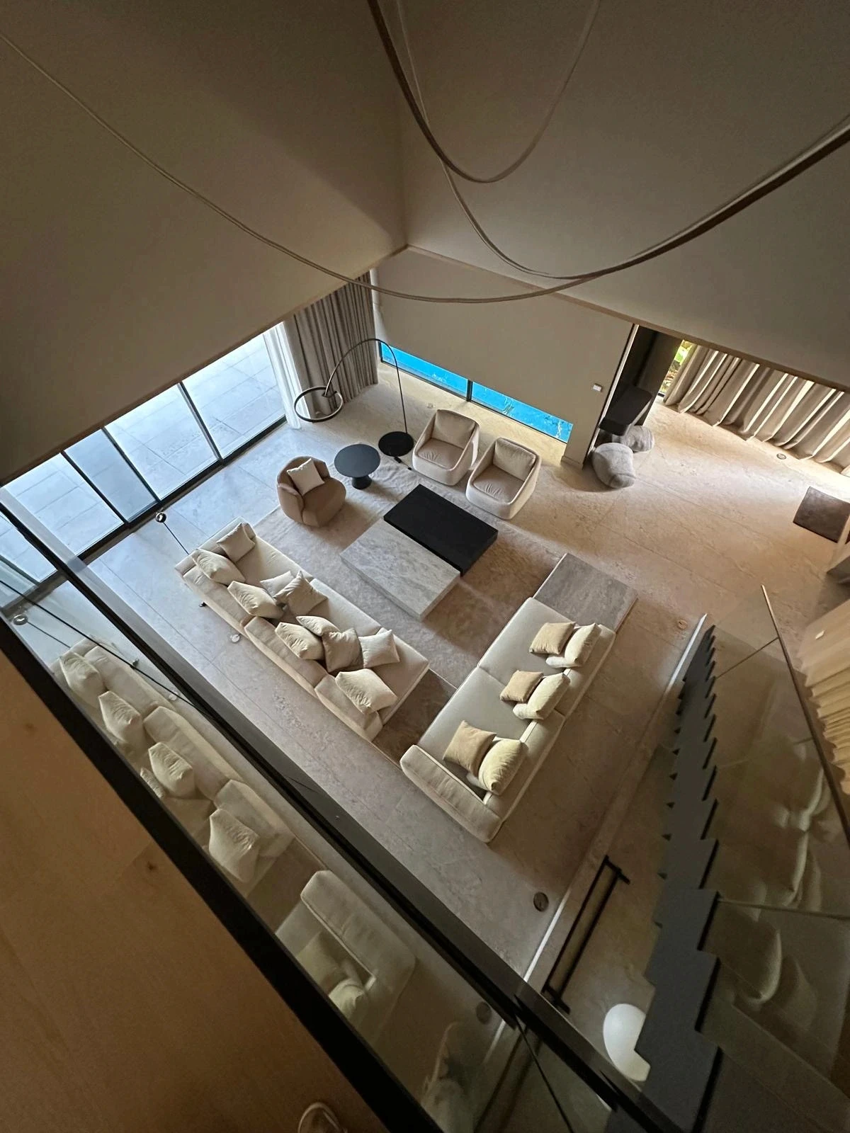 Overhead view from the mezzanine of the double-height living room at the Meridian Avenue Residence in Miami Beach by Atelier International.