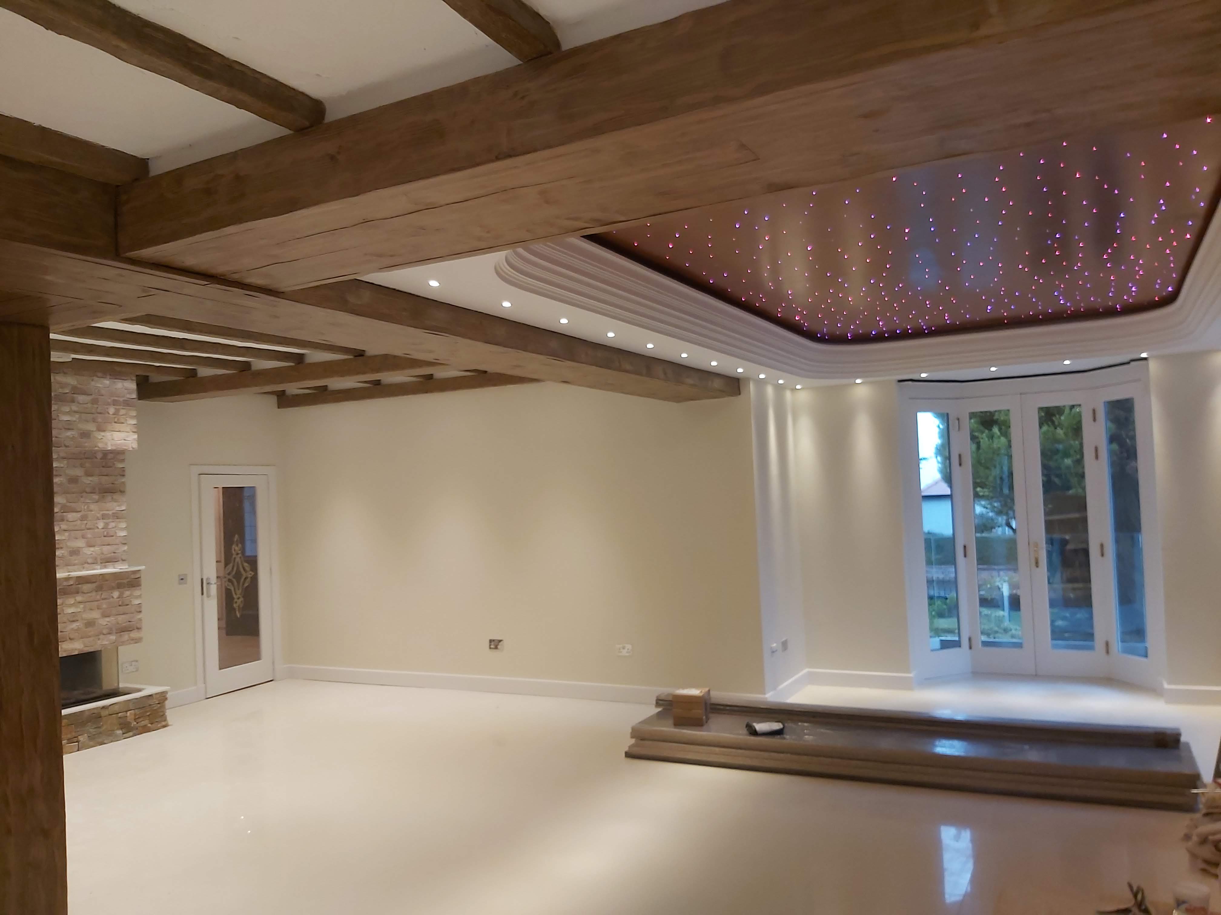 Inside a room with white walls and wooden beams