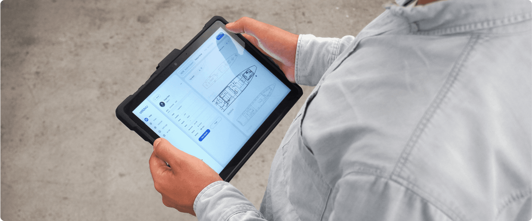 Person holding a tablet displaying a tracking dashboard, featuring real-time data and analytics for monitoring various metrics or devices.