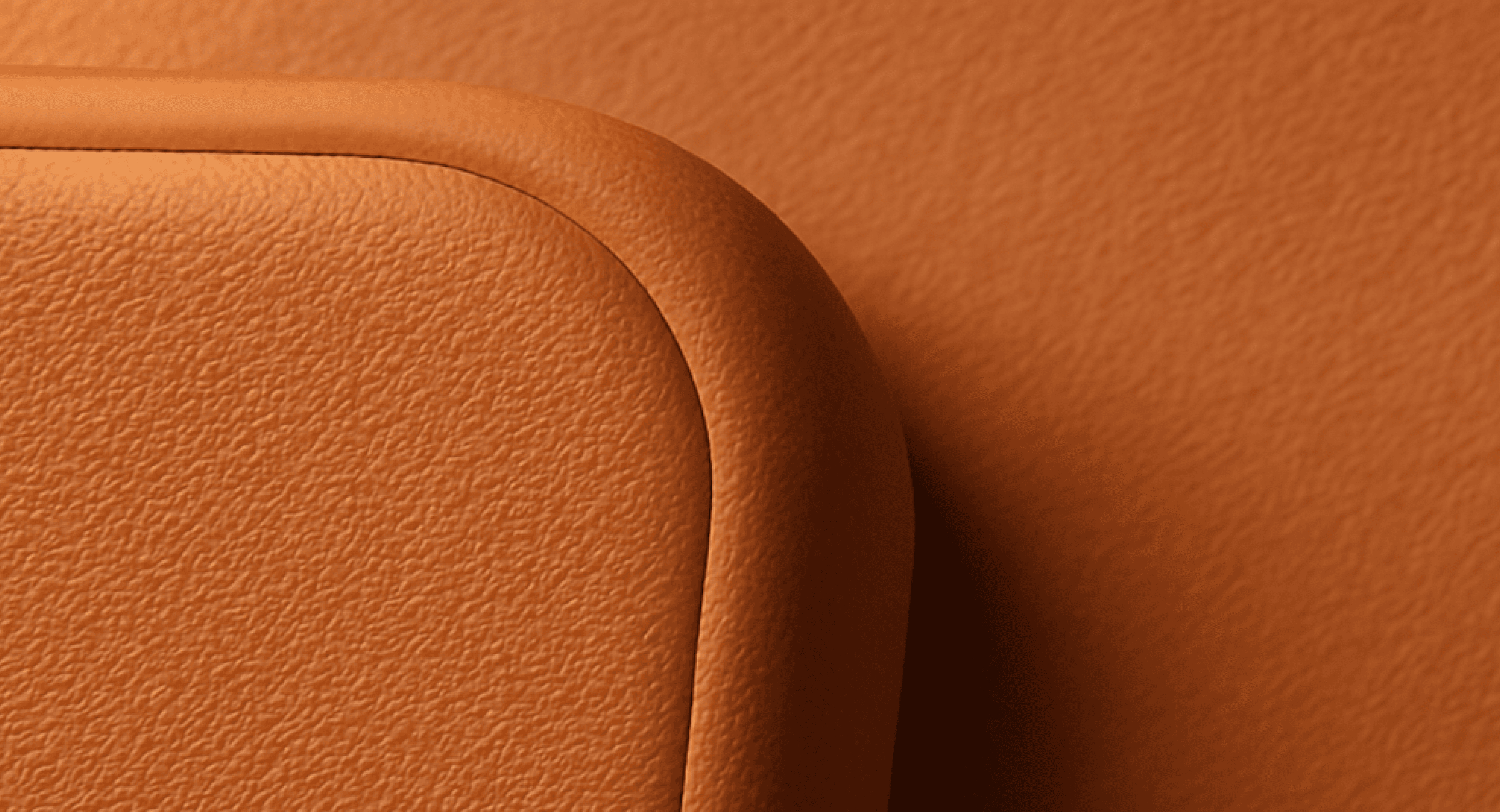 Close-up of a textured orange corner of a curved object against background.