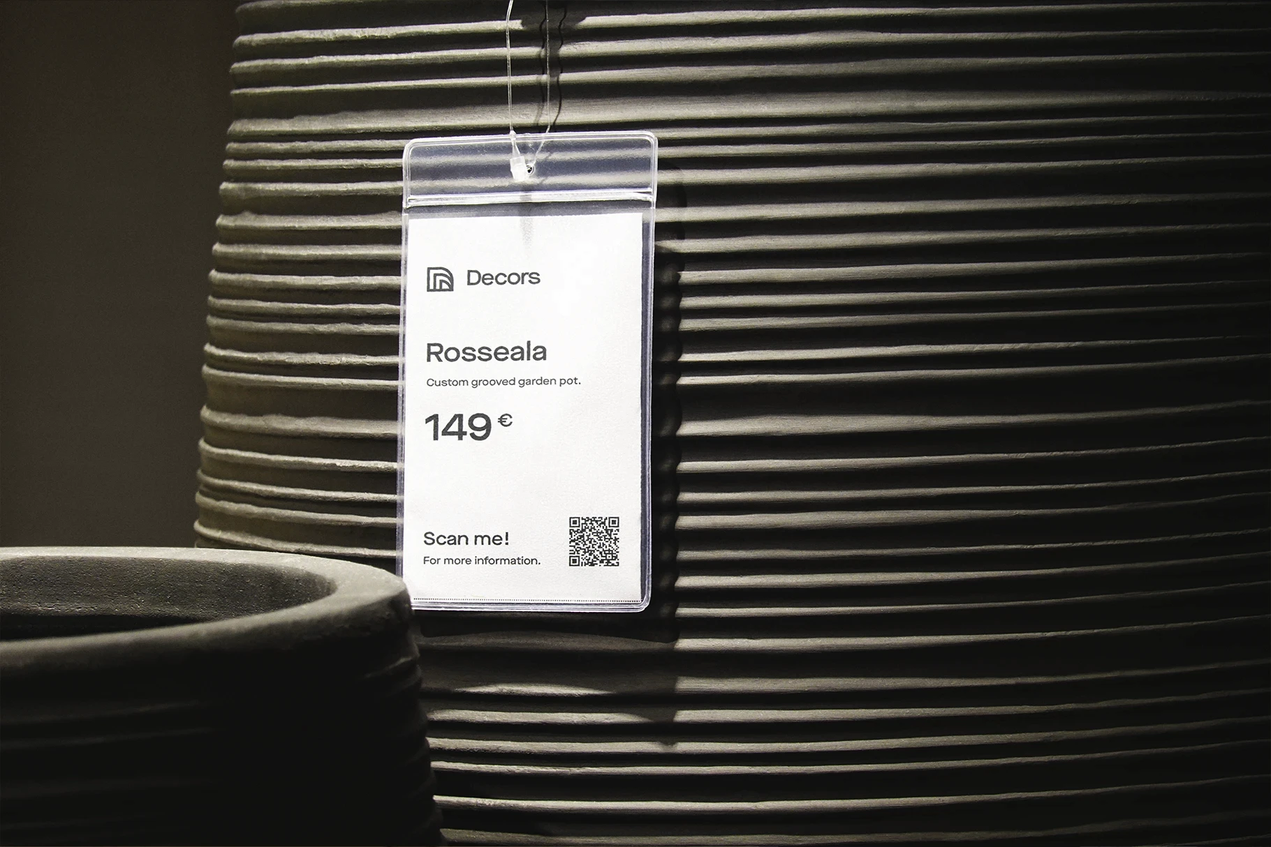 Product tag mockup with a blue header, hanging from a dark ribbed pot.