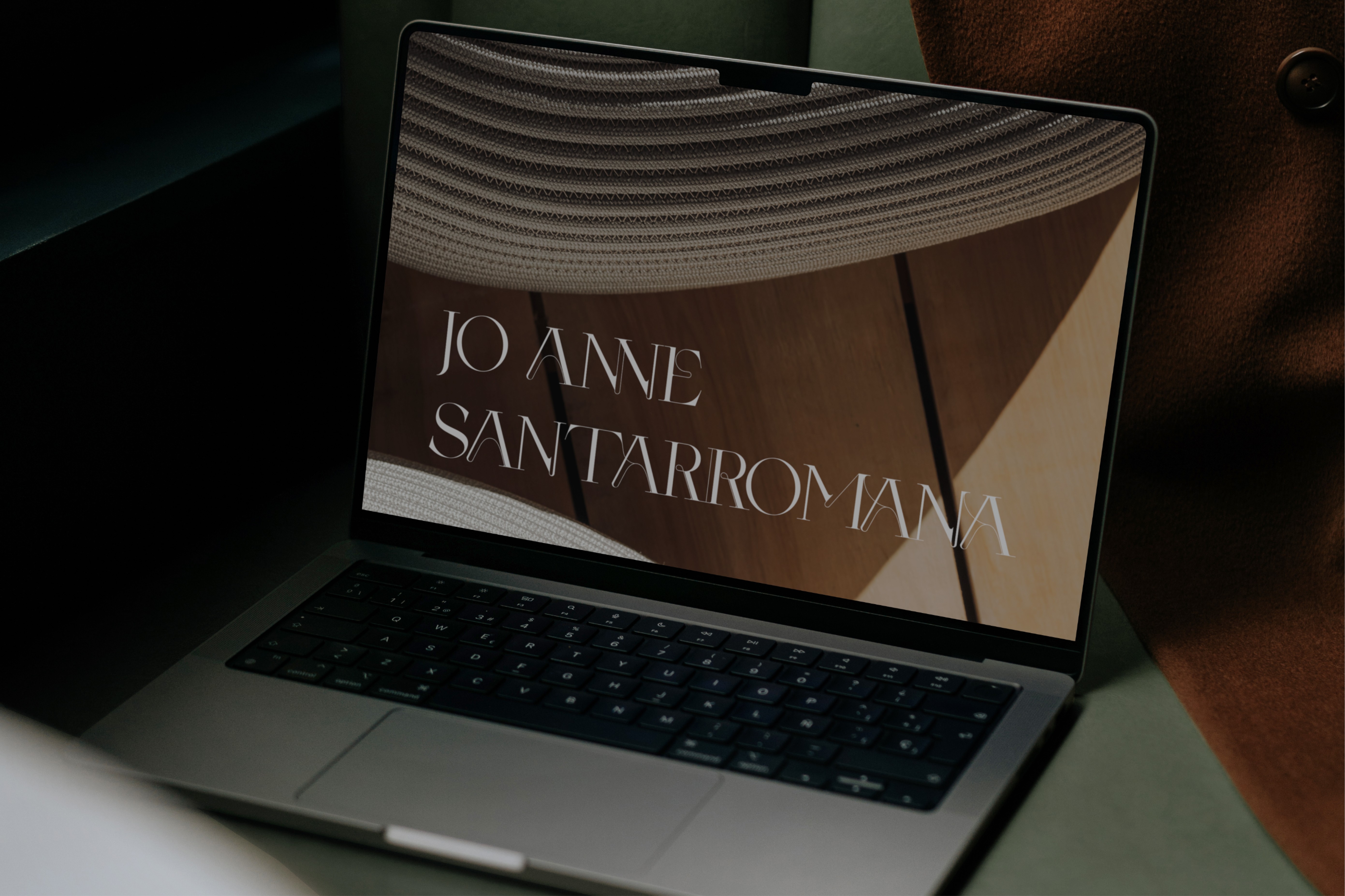 Laptop displaying Jo Anne Santarromana’s refined logotype, reflecting the brand’s sophisticated and design-forward real estate identity.