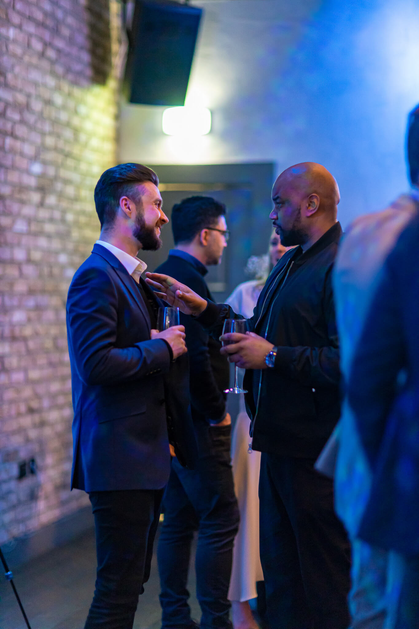Guests talking during a networking event in a softly lit venue