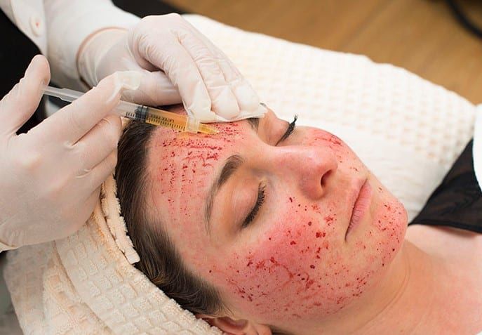 Woman's face with cleansing foam during facial treatment.
