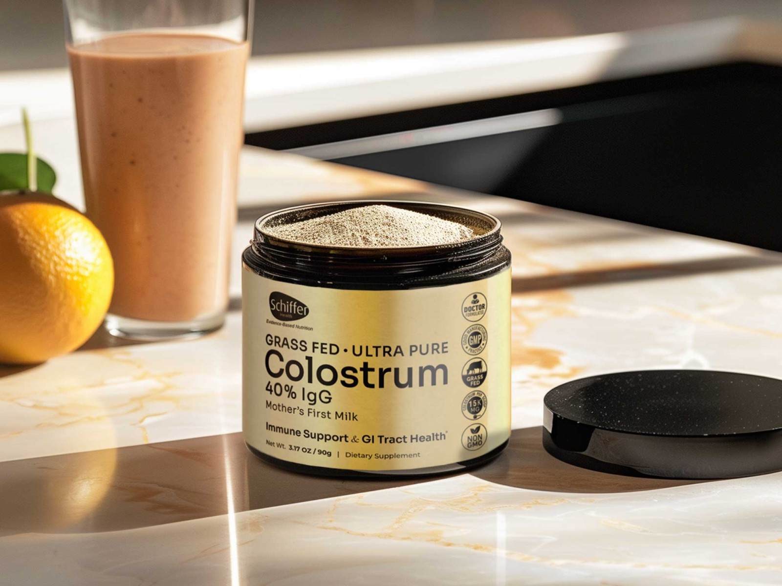 Product photography of a supplement container labeled "Colostrum" alongside a smoothie in a glass and fresh fruit, arranged on a white surface with natural lighting.